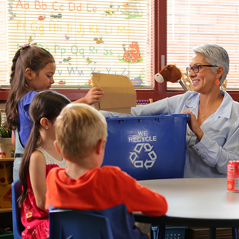 Teacher showing how to recycle