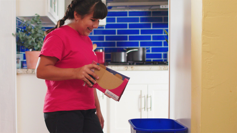 Child recycling cardboard