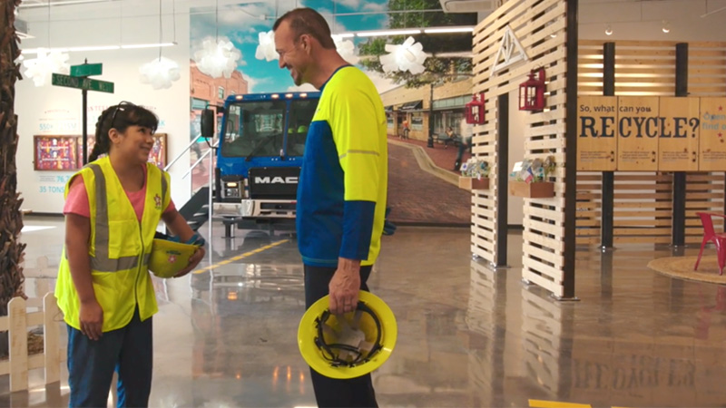 Employees discussing in front of installation