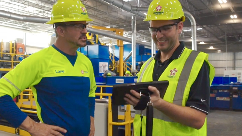 Employees discussing over iPad screen
